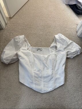 Cropped white top with puff sleeves